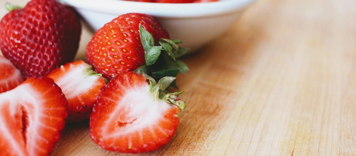 photo of strawberries in bowl on table